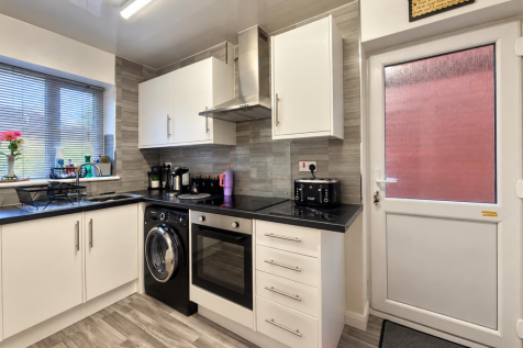 Modern Grey and White Kitchen Interior.png