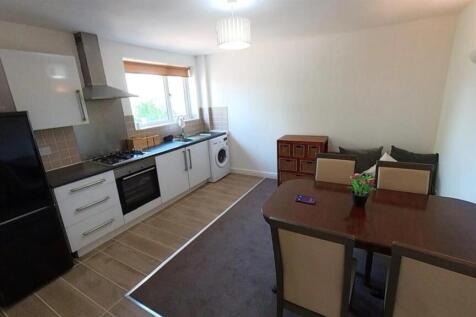 Bright kitchen with modern units and dining are...