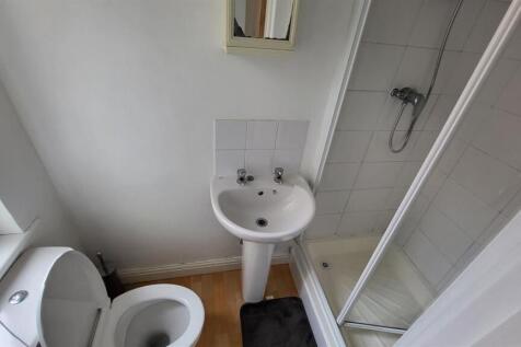 Clean and bright bathroom with a walk-in shower...