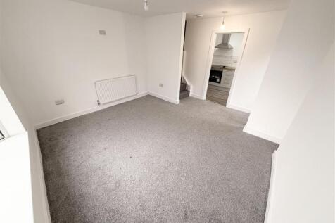 Bright and airy lounge with plush grey carpet...