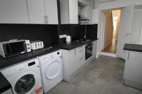 Modern kitchen with sleek white cabinets....