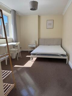 Bright bedroom with double bed and study desk...