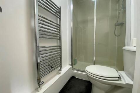 Modern bathroom with shower and heated towel ra...