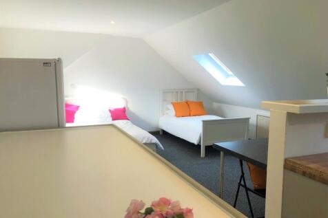 A bright and clean double bedroom featuring two...