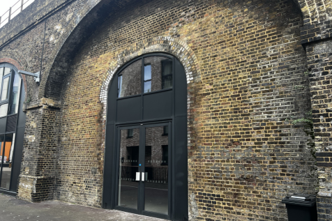 The front of an arch, with glazing on the bottom half and door allowing you to see into the arch interior.