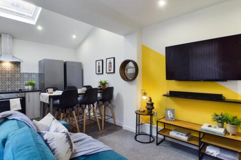 A bright and inviting large modern living room ...