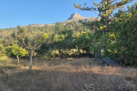 Land with small house 