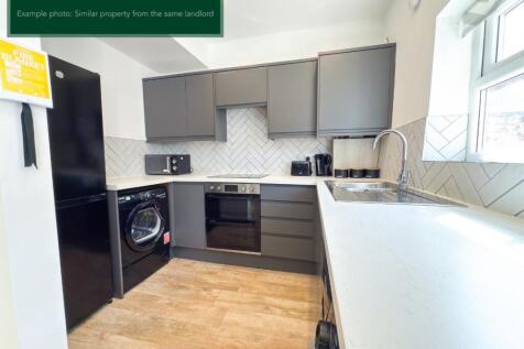 Modern kitchen with sleek grey cabinetry....