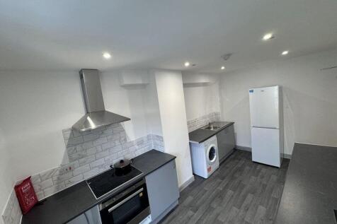 Modern kitchen with sleek grey countertops, sta...