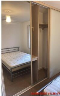 Bright, simply furnished double bedroom with a ...
