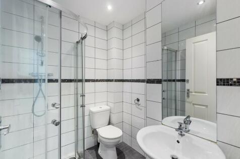 A clean and modern bathroom featuring a shower ...