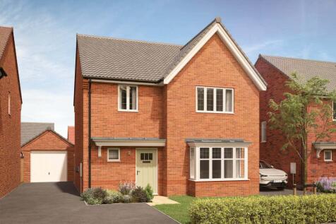 A modern red brick house with a light green door and bay windows sits in the foreground
