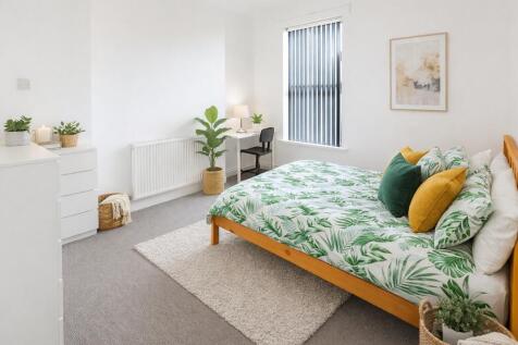 Bright bedroom with study desk and stylish deco...