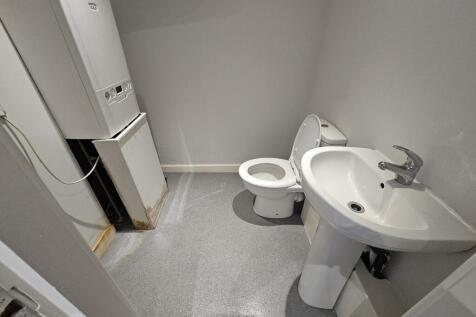 Clean compact bathroom with basin and WC...