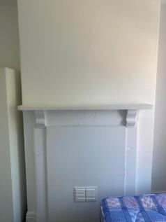 Bright bedroom corner with a painted decorative...