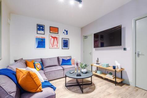 Bright, modern living room with a comfortable L...