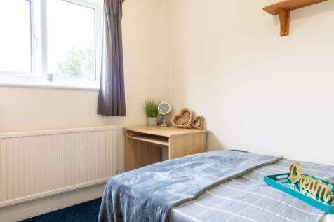 Bright, simply furnished single bedroom with a ...