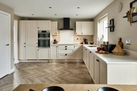 The modern kitchen is light and has ample storage and worktop space
