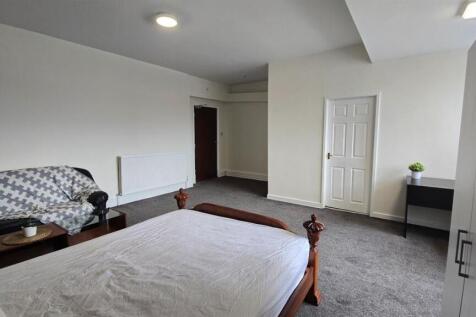 Spacious bedroom with sofa and study desk...