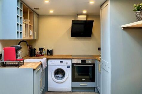 Modern fitted kitchen with sleek appliances...
