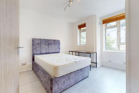 Bright modern bedroom with stylish plush bed...