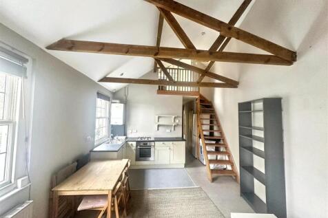 Bright kitchen/diner with exposed beams...