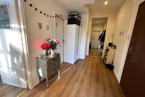 Bright, welcoming hallway with wood-effect floo...