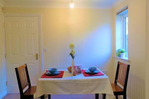 A cozy dining area featuring a neatly set table...