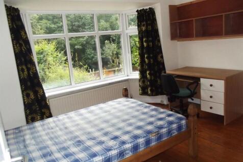 Bright bedroom with large window and study area...