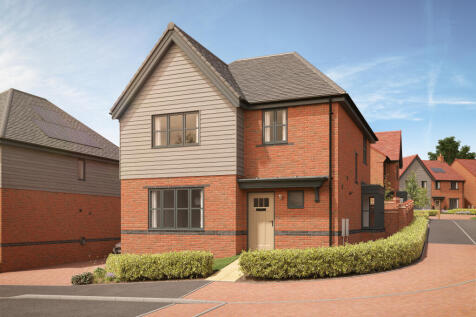 A modern brick house with a grey upper story sits behind a neatly trimmed hedge