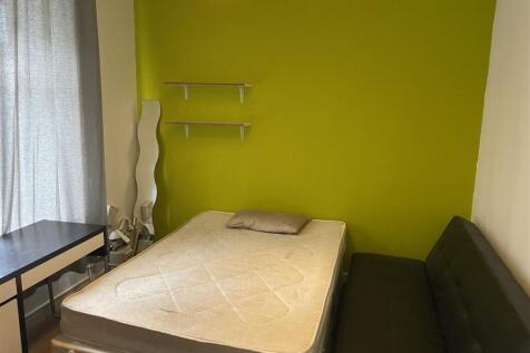 Bright bedroom with feature wall and study desk...