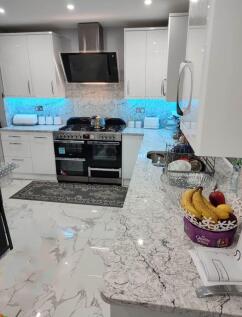 Modern kitchen with sleek marble-effect finishe...