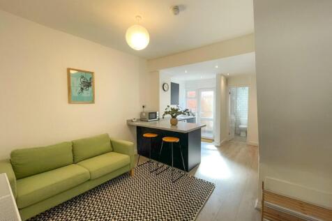 A spacious and modern living room featuring a c...