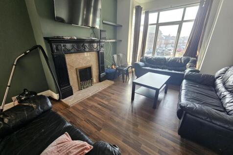 Bright lounge with bay window and fireplace...