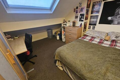 Comfortable attic double bedroom with a skyligh...