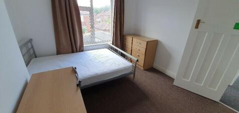 Bright bedroom with study desk and storage...
