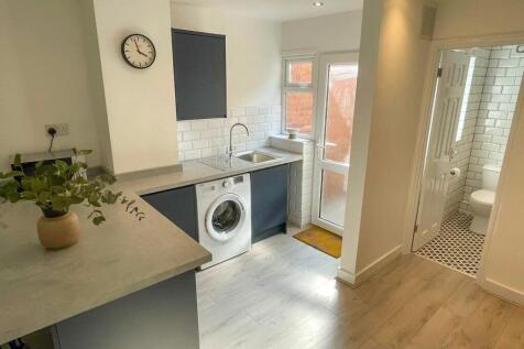 A bright and modern kitchen featuring ample spa...