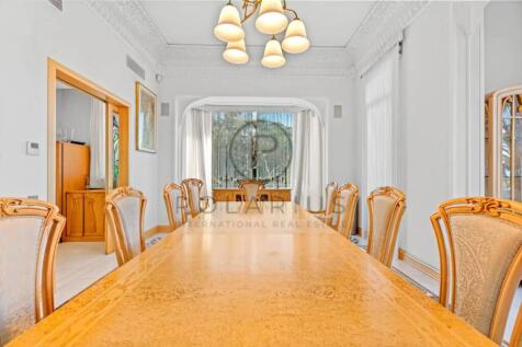 The image shows an elegant dining room with a long