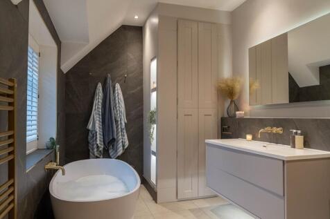 Large family bathroom with stone resin bath and LED mirror