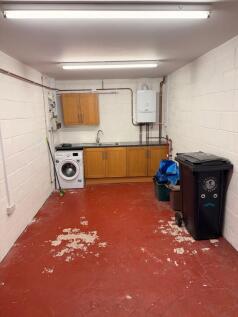 Spacious laundry area with sink and storage....