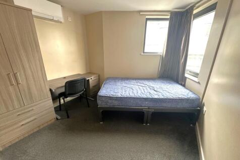 Bright, simply furnished bedroom with a single ...