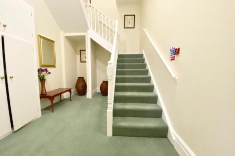 STAIRCASE LEADS TO FIRST FLOOR
