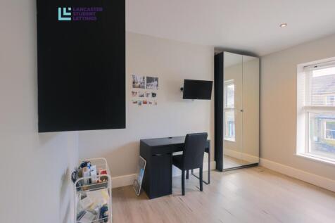 Bright modern bedroom with desk and mirror...