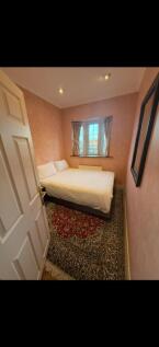 Cosy double bedroom with ornate patterned rug...