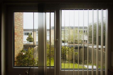 Bright window view overlooking a lush green gar...