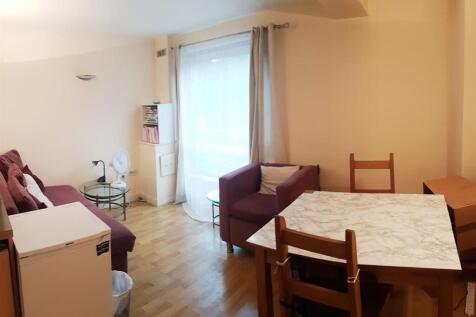 Bright living area with dining table and seatin...