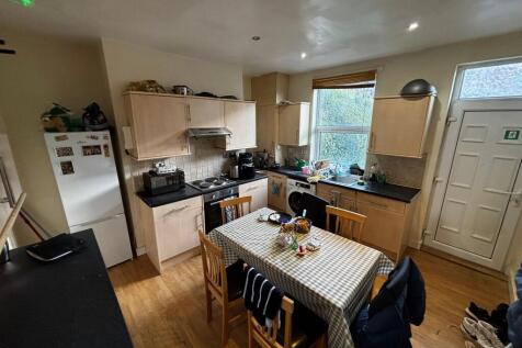 Bright, practical kitchen with a central dining...