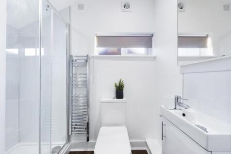 A modern and stylish bathroom featuring a sleek...