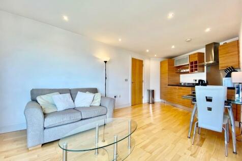 Bright open-plan living with stylish wood floor...