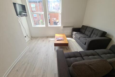 A bright and inviting living room featuring two...